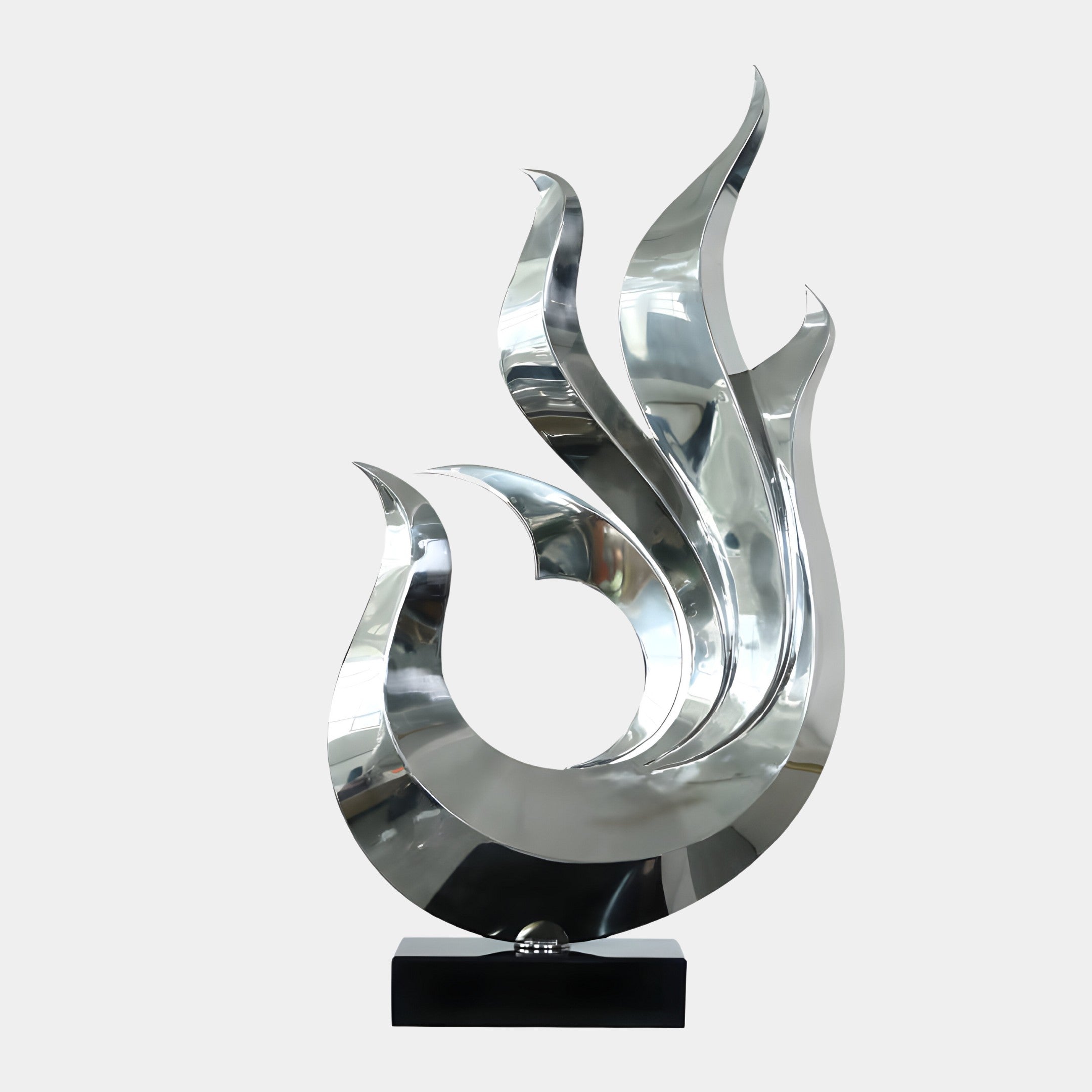 A flame-shaped silver sculpture with sharp curves, mounted on a black pedestal.