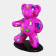 The Gacko Keith Haring Pink Bear Sculpture by Giant Sculptures is a pop art marvel, featuring a glossy pink bear adorned with vibrant yellow, blue, red, and green human-like figures. It stands on a black oval base and is slightly angled to the right against a plain background.