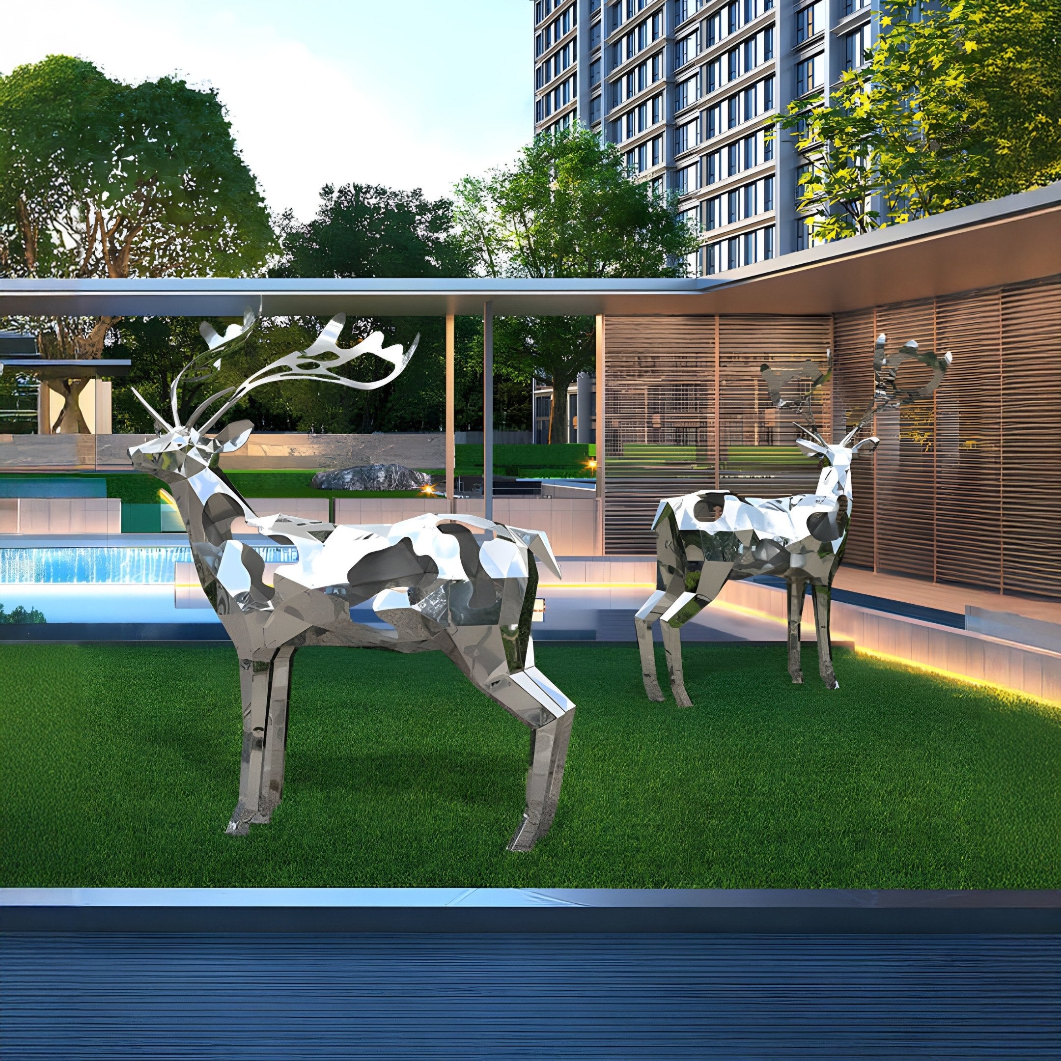 Two Mystic Deer II Geometric Steel Sculptures by Giant Sculptures grace a lush lawn near a modern building, with a pool and trees in the background. Their geometric design enhances the sleek architecture, adding modern art flair to the urban landscape.