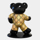 Gacko Gucci Bear Sculpture by Giant Sculptures is a glossy black 165cm bear on a round base, donning a golden outfit. It features an interlocking G pattern and green-red-green stripes, evoking iconic pop art collaborations with high-end fashion flair.