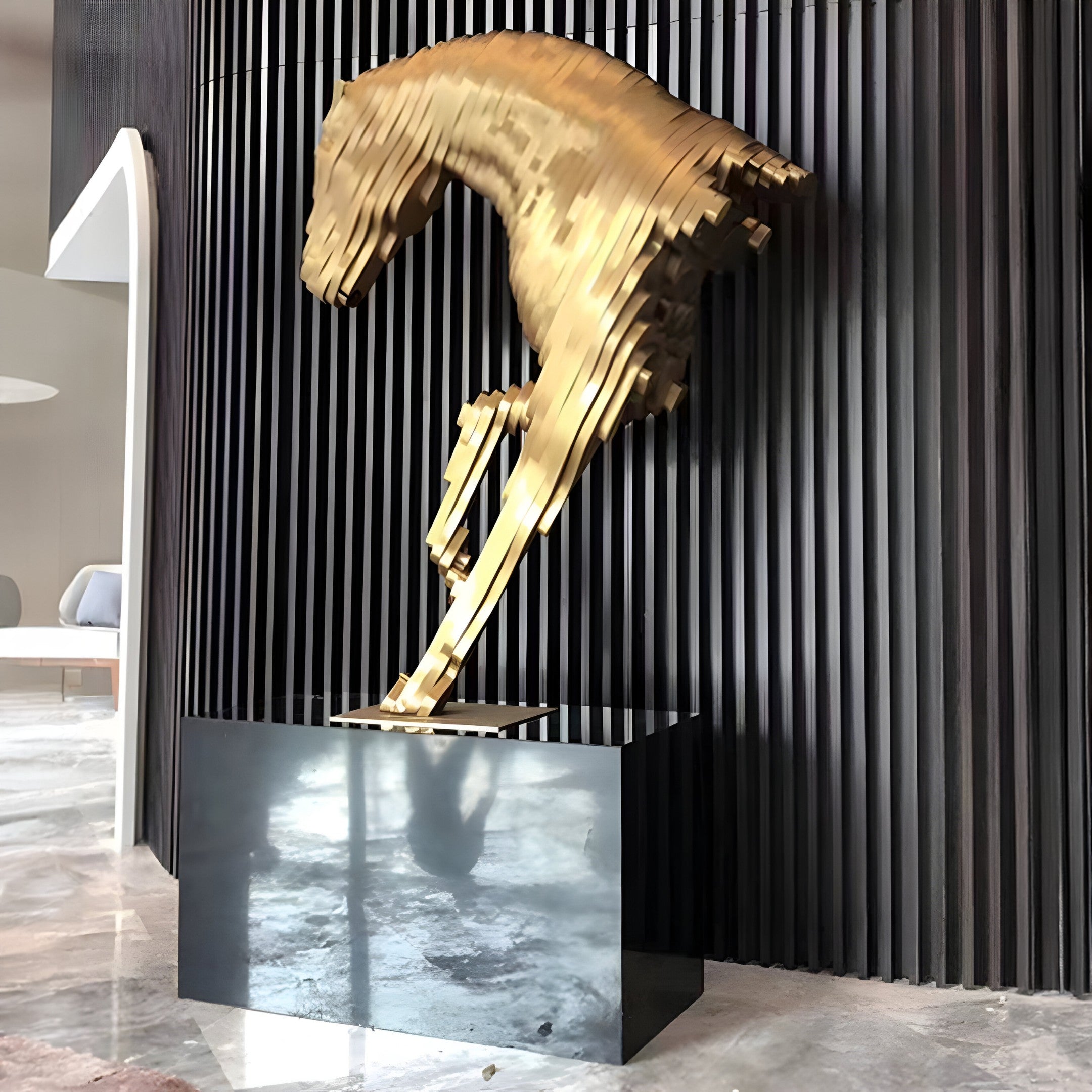 Elegant gold horse sculpture displayed in a high-end interior, adding luxurious charm with a modern abstract design.