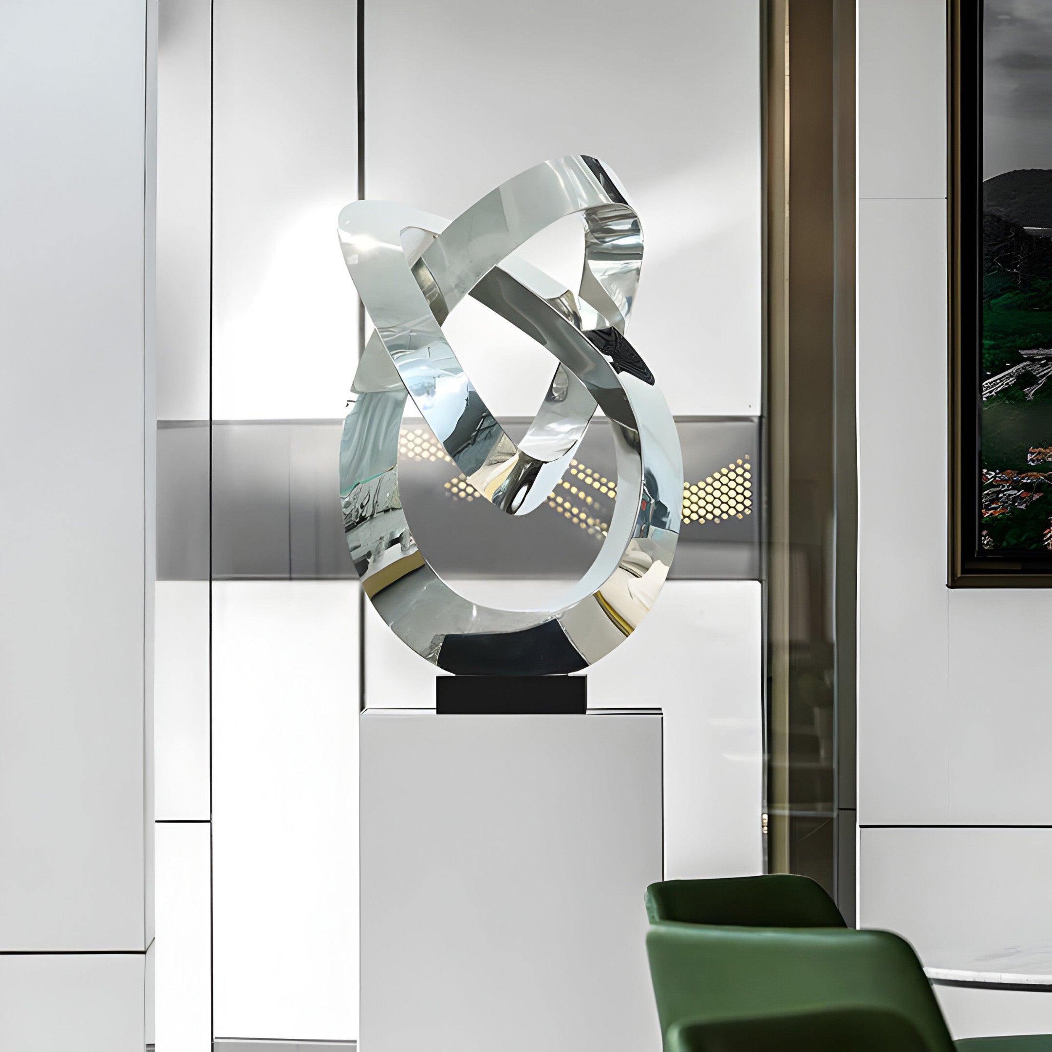 A different view of the silver sculpture in a contemporary interior setting.