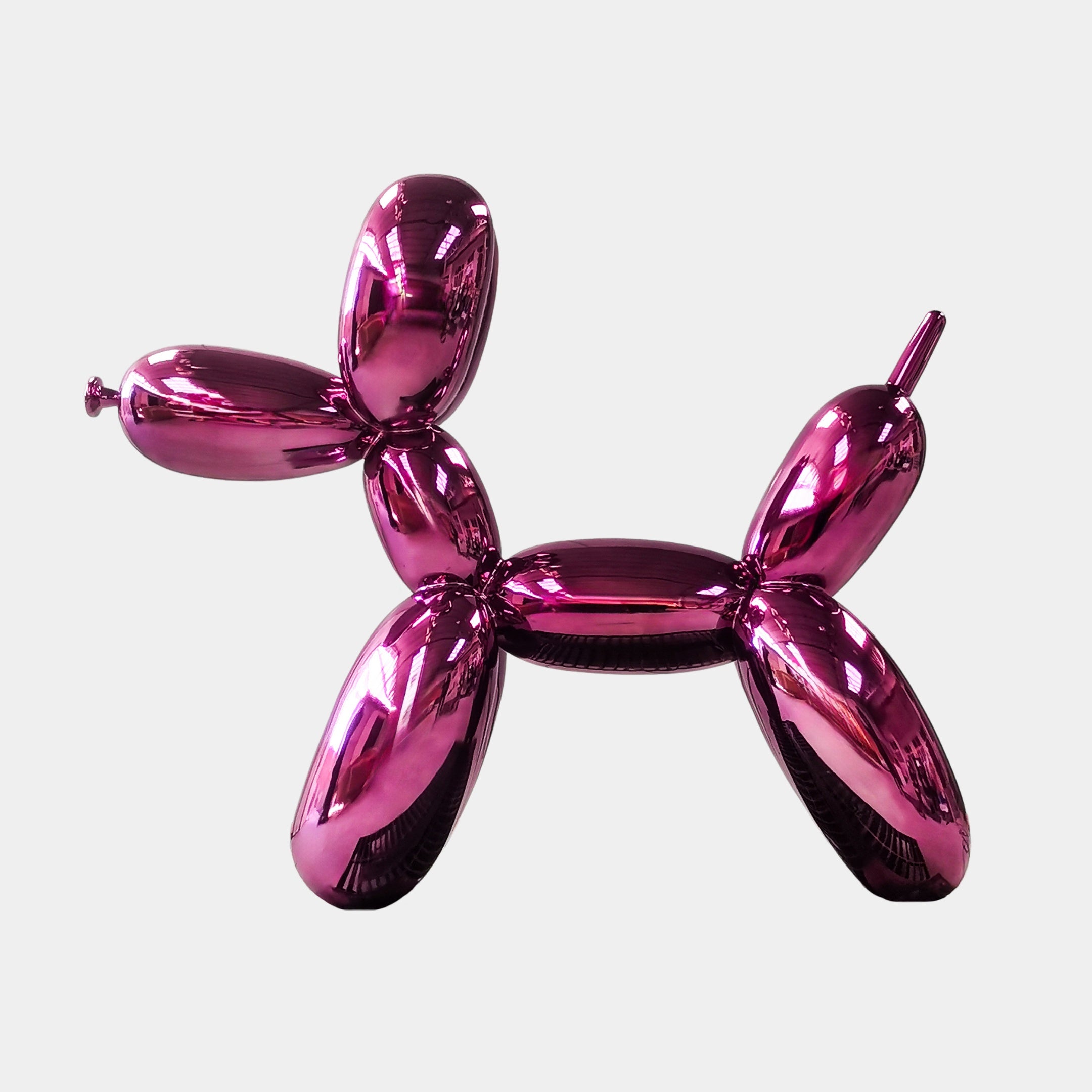 The Phantom Purple Balloon Dog Sculpture - 80cm by Giant Sculptures, a highlight of contemporary art, stands out against a white background with its radiant metallic pink finish.