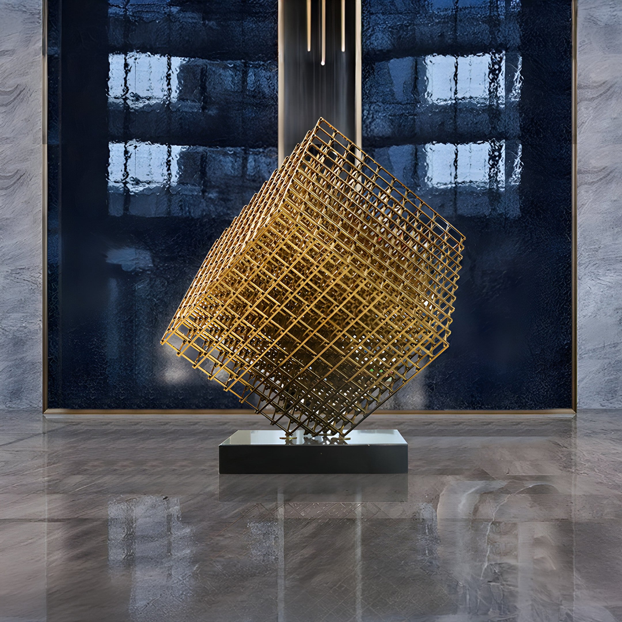 A contemporary geometric sculpture from Giant Sculptures, featuring a large Matrix Silver Geometric Steel design with an open grid structure, is showcased on a polished reflective floor. The backdrop includes a textured blue wall with vertical lighting, enhancing the modern atmosphere.