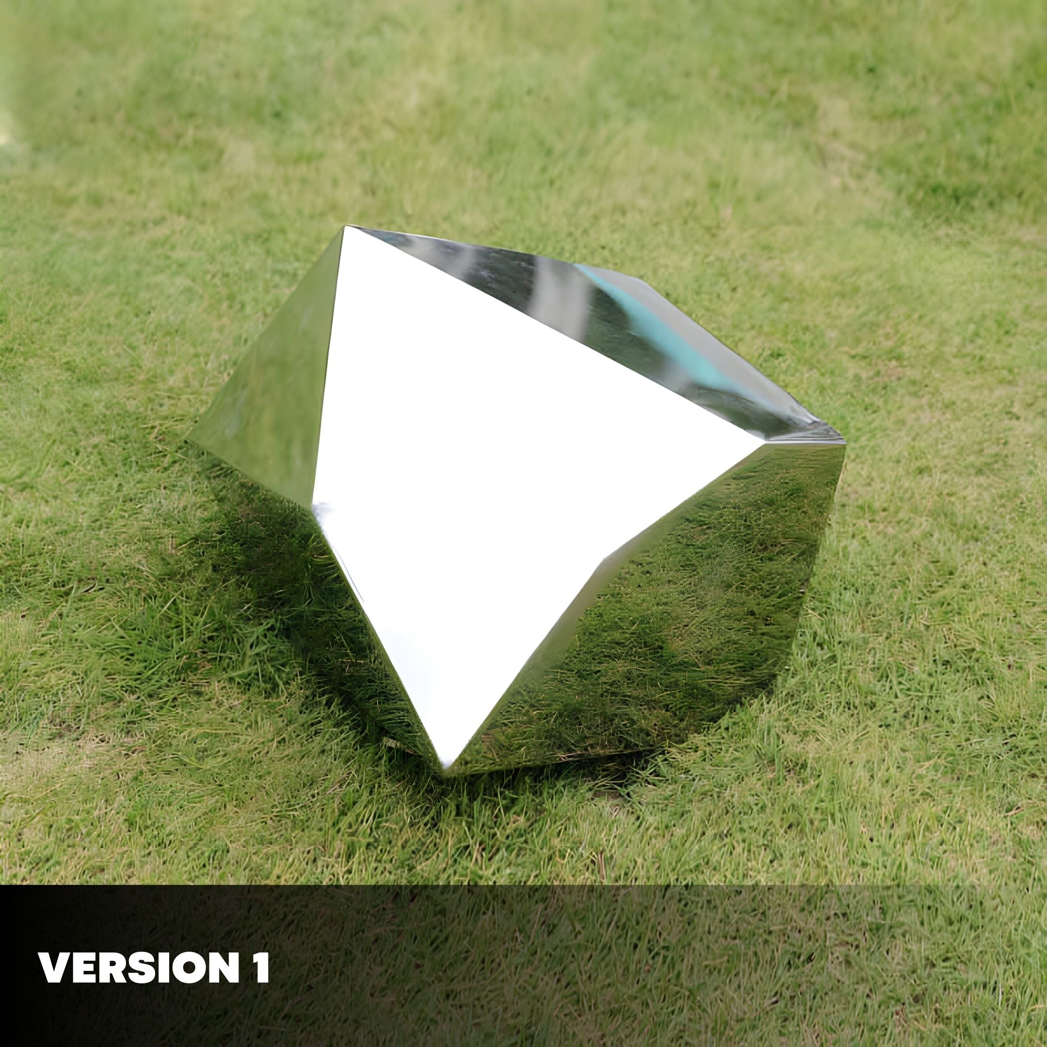 The Tetra Geometric Steel Rock Sculpture by Giant Sculptures features angular facets and a metallic finish resembling a diamond. It gleams in natural light on a grassy surface, with VERSION 1 in the bottom left, exuding contemporary elegance.