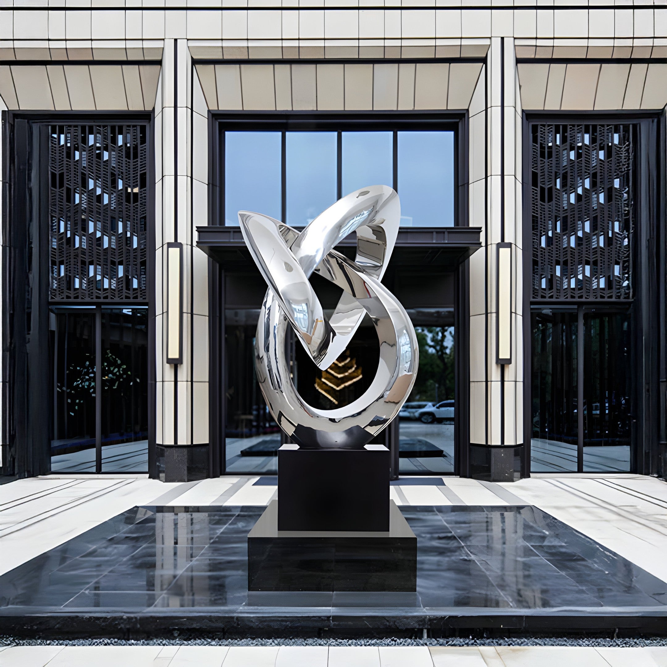 The sculpture displayed in front of a luxury building entrance, reflecting surrounding architecture.