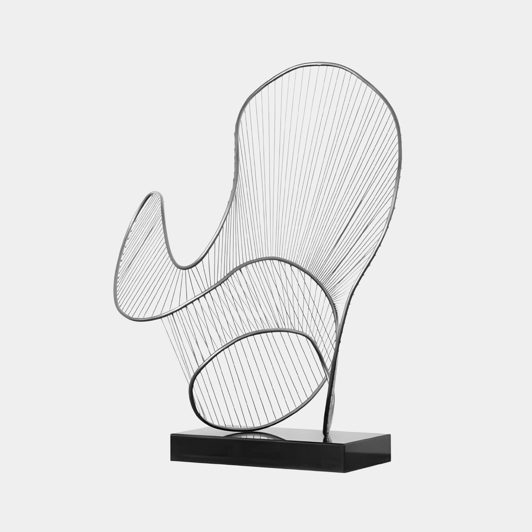 The Cheri Silver Abstract Steel Sculpture - 72cm by Giant Sculptures presents a modern wire design crafted from stainless steel, showcasing an abstract and dynamic arrangement of curved lines and loops on a rectangular black base. This silver sculpture exudes a sense of movement and lightness when displayed against a simple background.