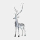 The Luminous Stag Silver Steel LED Sculpture by Giant Sculptures, standing at 212cm, is elegantly set against a plain white backdrop. Crafted from silver stainless steel, its tall antlers showcase intricate detailing that captures and reflects light beautifully for a dazzling effect.