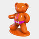 The Gacko Hermes Bear Sculpture by Giant Sculptures is 165cm tall and features an orange glossy teddy bear standing on a matching base. It includes a pink Hermès Paris logo belt and three chest buttons, with one arm raised as if waving—a chic Pop Art-Luxe piece for luxury interiors.