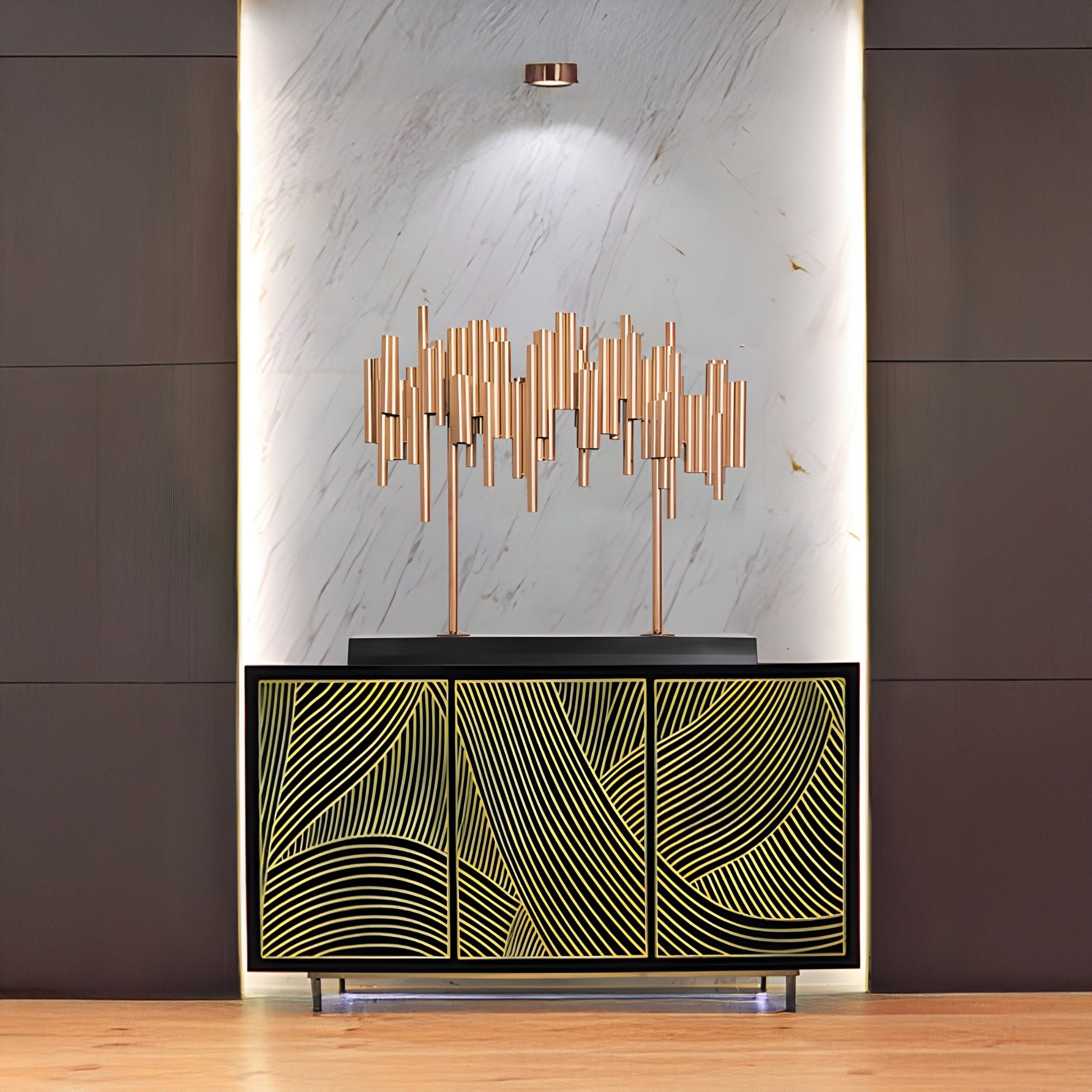 The Strata Long Copper Abstract Steel Sculpture - 90cm by Giant Sculptures, sits atop a cabinet with gold geometric designs. A marble-textured background with subtle lighting enhances the rooms elegant and contemporary aesthetic.