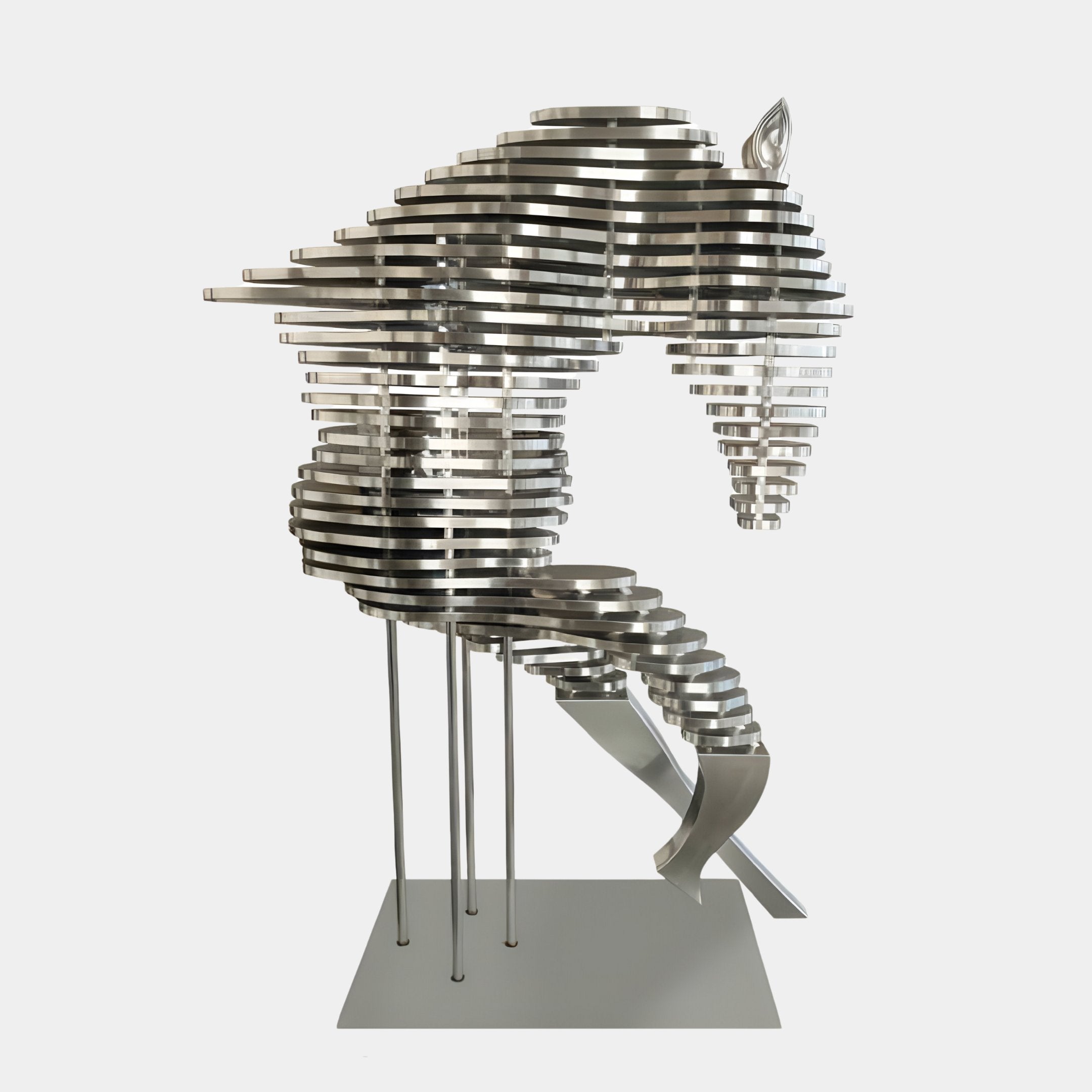 The Rising Stallion Silver Steel Horse Sculpture by Giant Sculptures features an abstract horse head and neck crafted from horizontal, layered bands in a contemporary design. Its reflective stainless steel surface enhances the sleek look, elegantly showcased on a minimalist base, standing at 160cm tall.