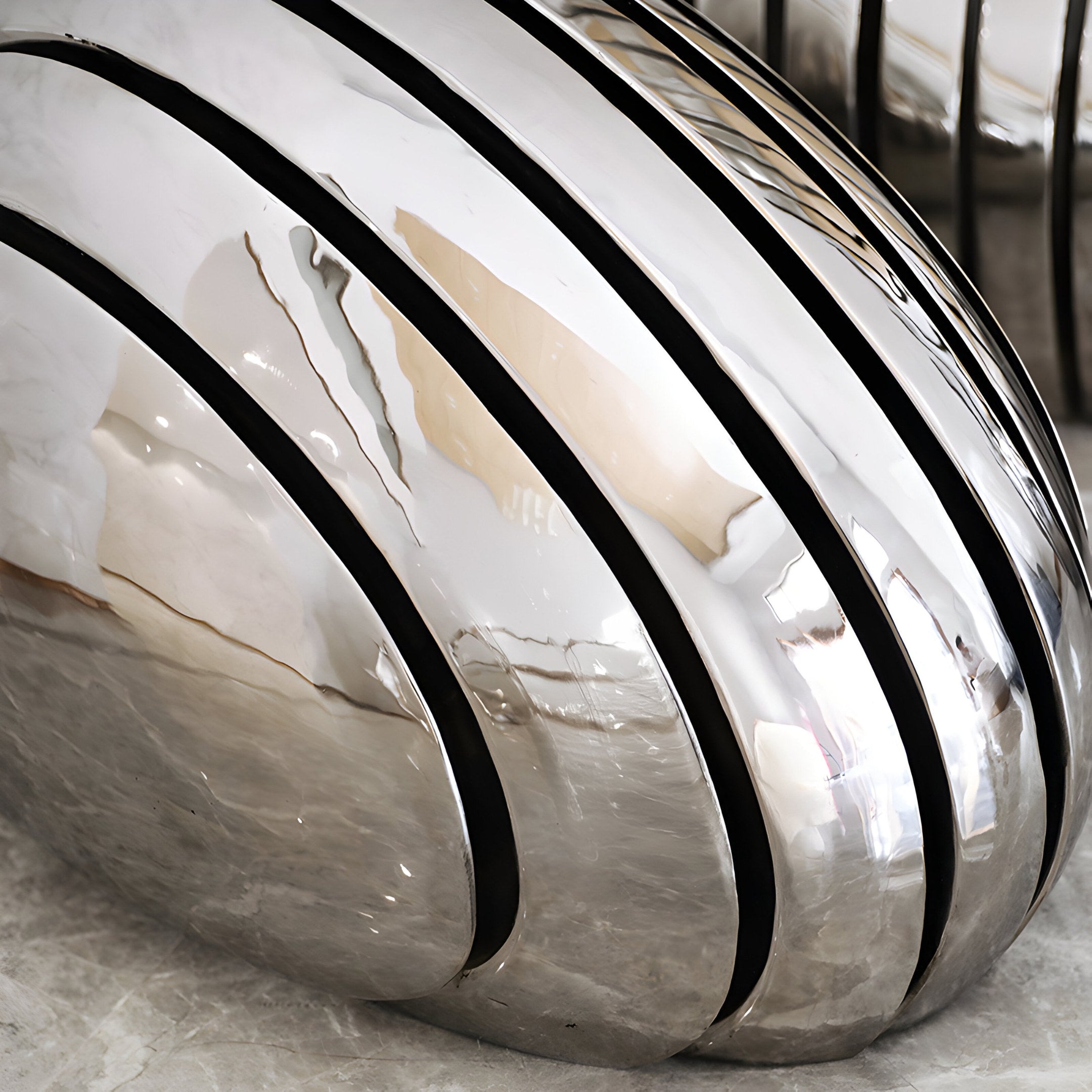 Smooth, reflective details of the Ripple sculpture’s flowing design.