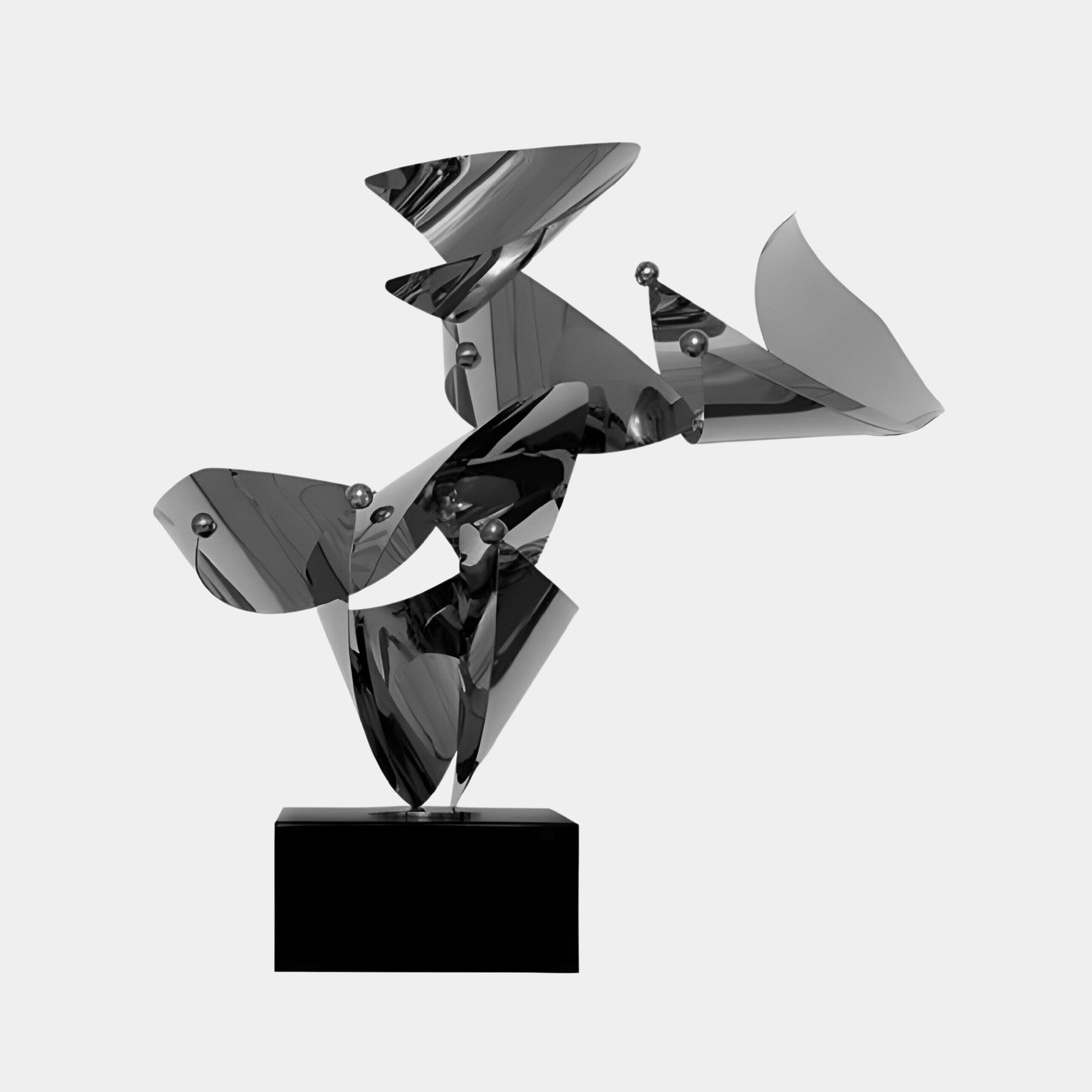 Silver abstract sculpture with a perforated texture on a black square base