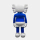 The Giant Sculptures Ex-Display Deep Blue Iconify Standing Sculpture features a modern design with a large, round head and wing-like ears. Standing 168cm tall, it wears a blue shirt, white shorts, matching gloves and shoes against a plain background, with its back turned to the viewer.