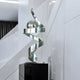 Abstract stainless steel twist sculpture displayed in a modern gallery-like setting, enhancing the space with its sleek, reflective curves.