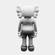 A monochrome figure with wing-like ears facing away, reminiscent of the Ex-Display Slay Grey Iconify Standing Sculpture by Giant Sculptures, has a smooth, stylized look wearing shorts and large shoes against a plain white backdrop.