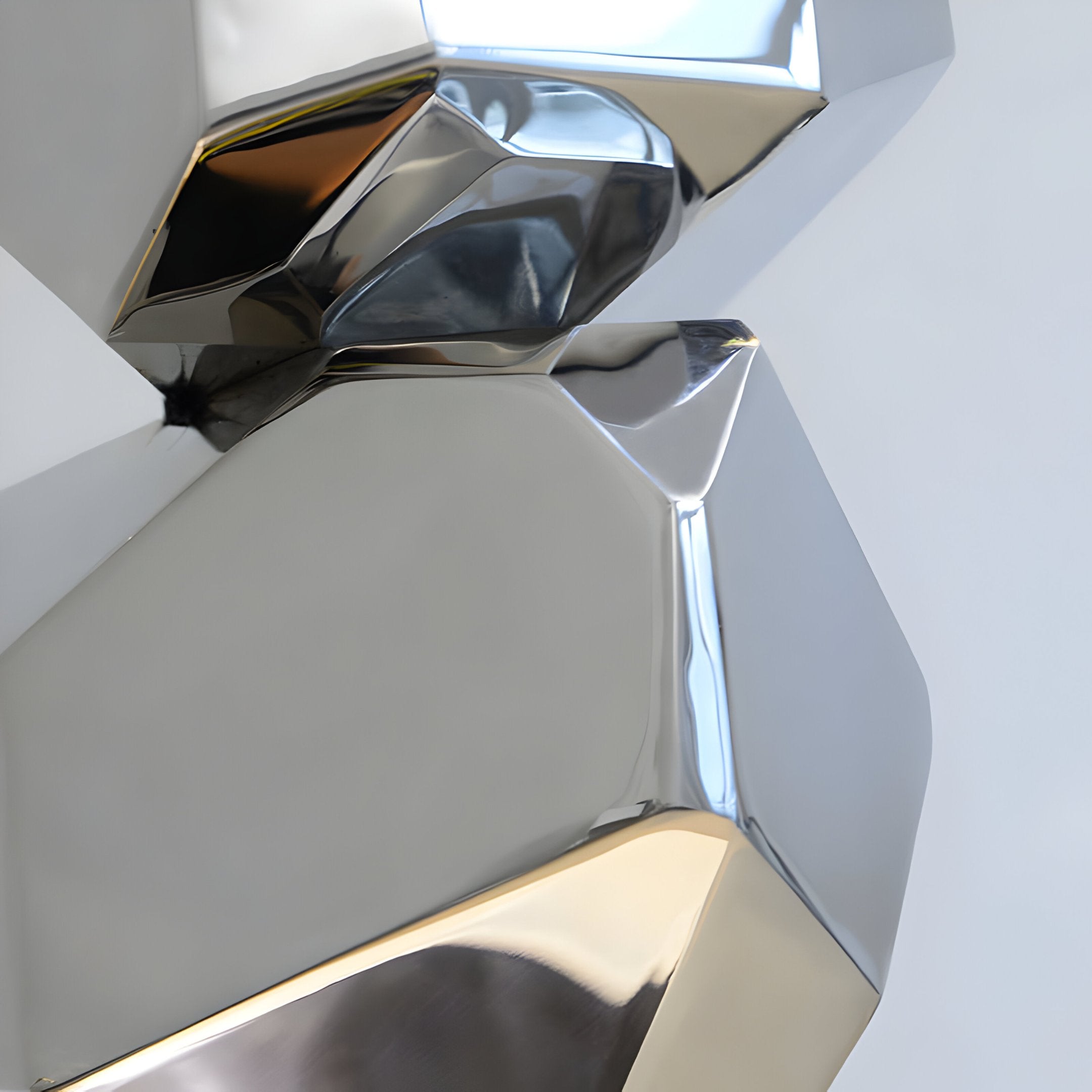 Close-up of the Monoform Stone Steel Sculpture - 90cm by Giant Sculptures, showcasing interlocking metallic shapes with smooth surfaces. The reflective silver material forms intertwining geometric designs, casting subtle shadows against a plain white background.