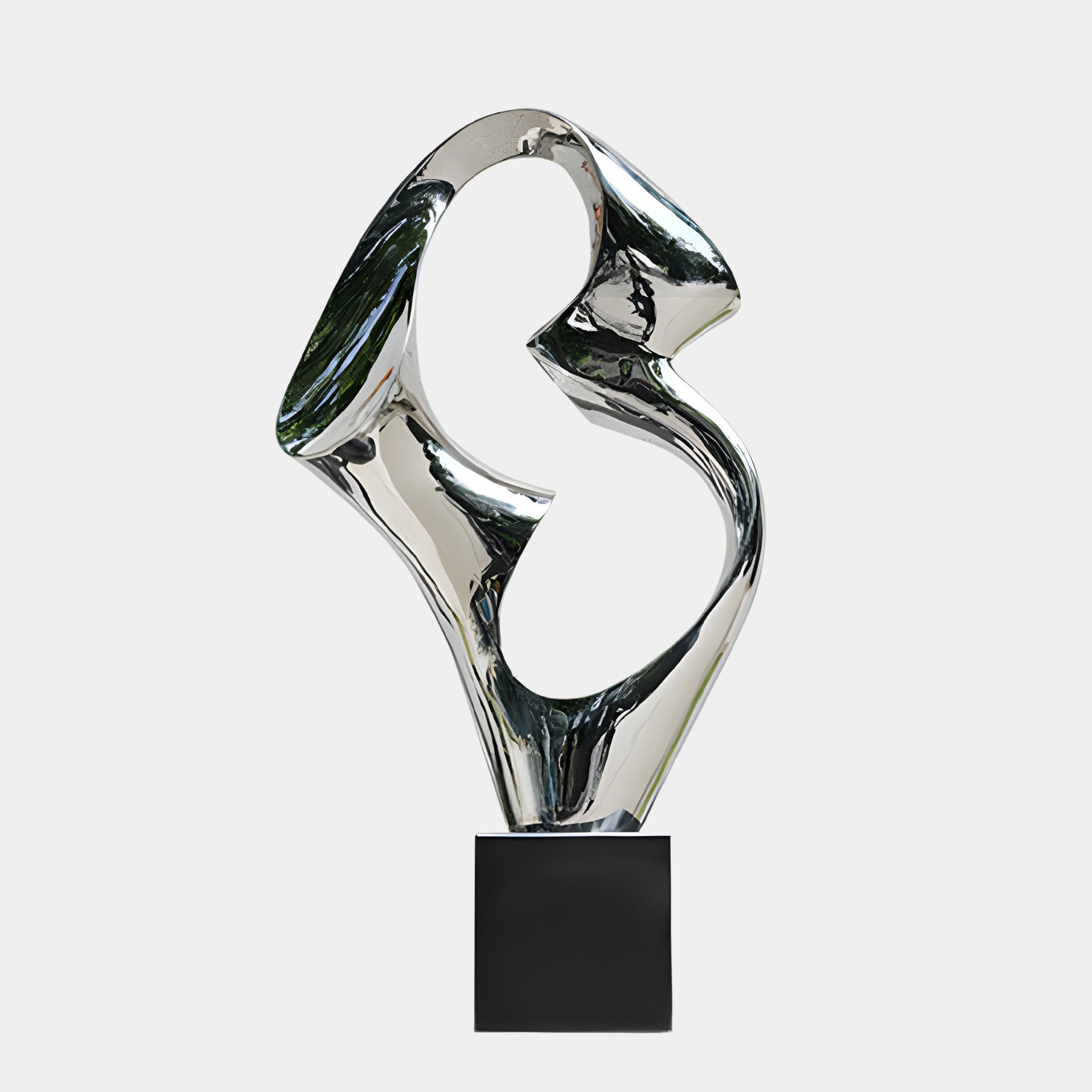 Silver abstract sculpture with a flowing, organic design, displayed on a black base.