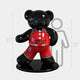 The Gacko Chicago Bulls Bear Sculpture, a 165 cm fiberglass piece by Giant Sculptures, features a shiny black bear in a red jersey and shorts on a black base, towering over a drawn outline of someone whos 150 cm tall.