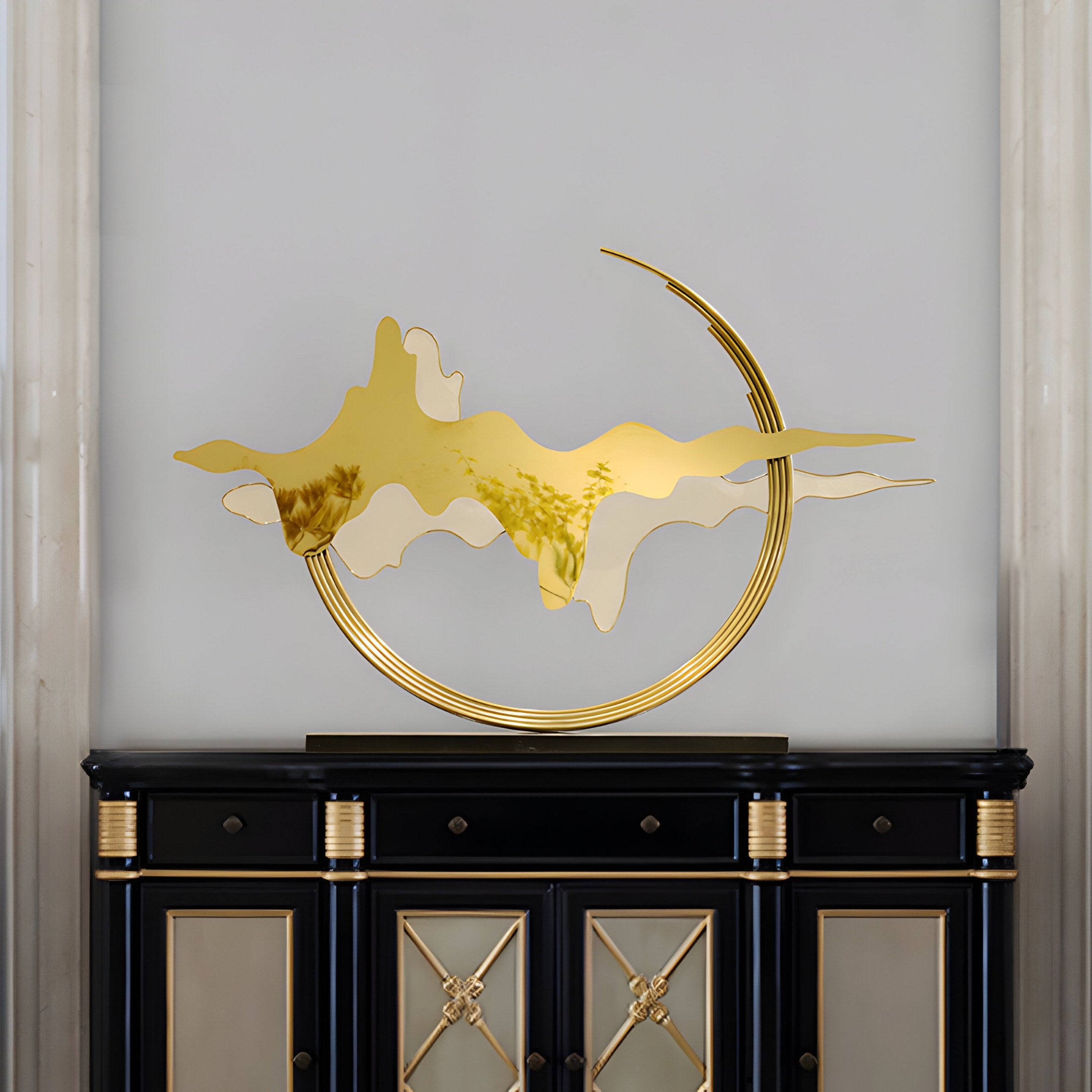 Horizon Gold Abstract Stainless Steel Sculpture placed on a sleek black cabinet, with golden curves catching the light.