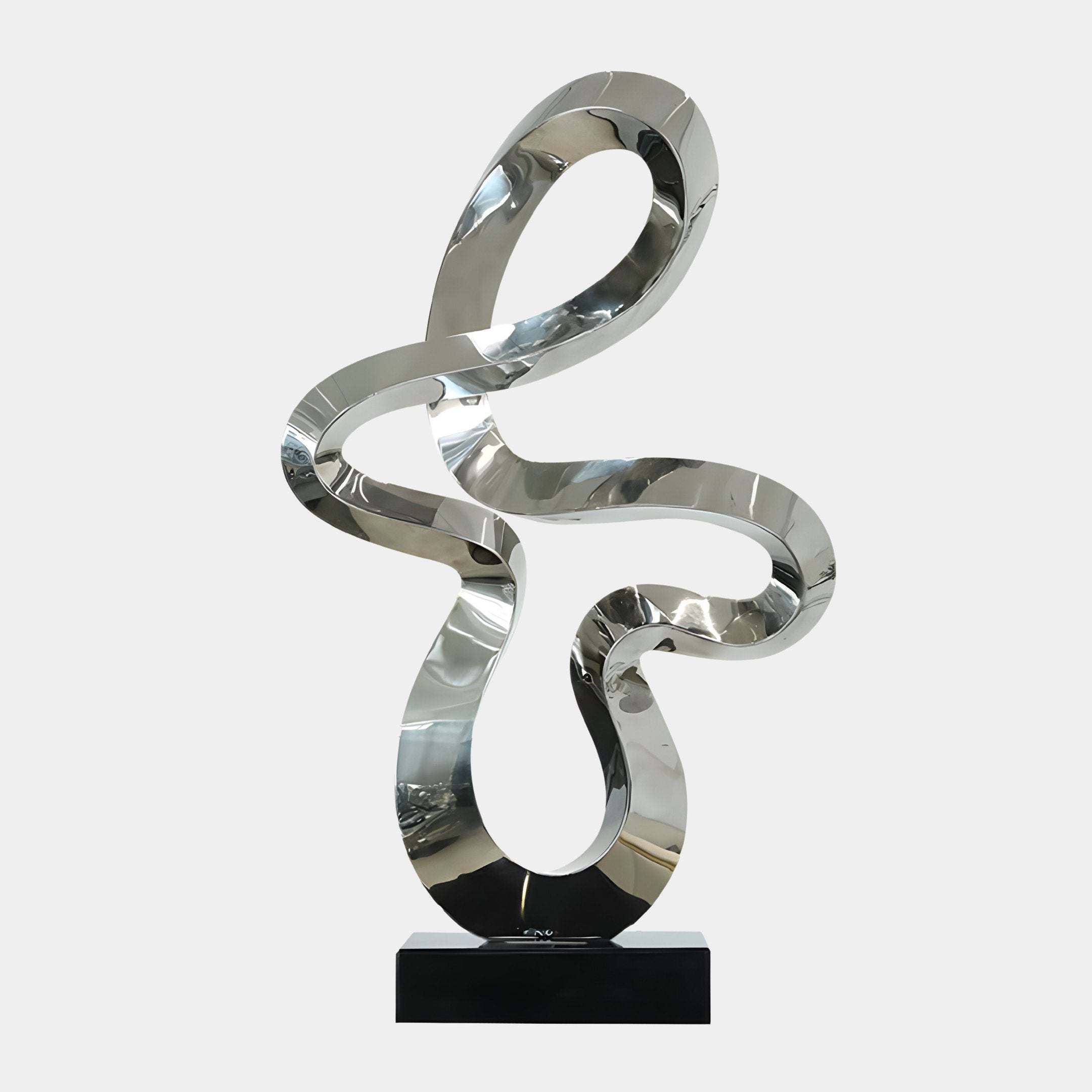 The Serpentine Silver Abstract Steel Sculpture - 87cm by Giant Sculptures stands on a black base against a plain white background, featuring shiny, smooth curving loops and twists that capture the essence of modern art.