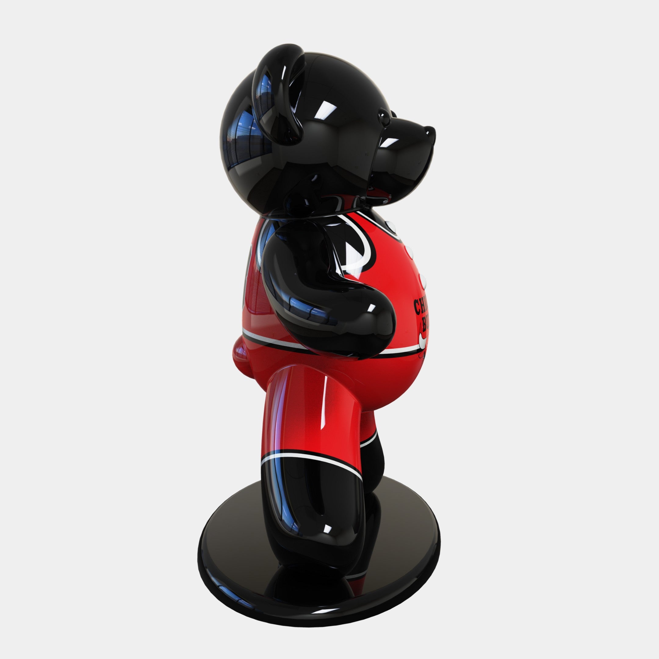 The Gacko Chicago Bulls Bear Sculpture by Giant Sculptures, standing 165cm tall, features a glossy black bear on a round base. Its shiny red outfit with white and black details reflects the Chicago Bulls colors, with the bear posed standing and slightly left-facing.