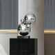 The Molecular II Silver Geometric Steel Sculpture - 55cm by Giant Sculptures features four asymmetrically stacked chrome spheres on a black marble pedestal. Vertical blinds and subtle lighting emphasize reflections on this molecular-inspired design.