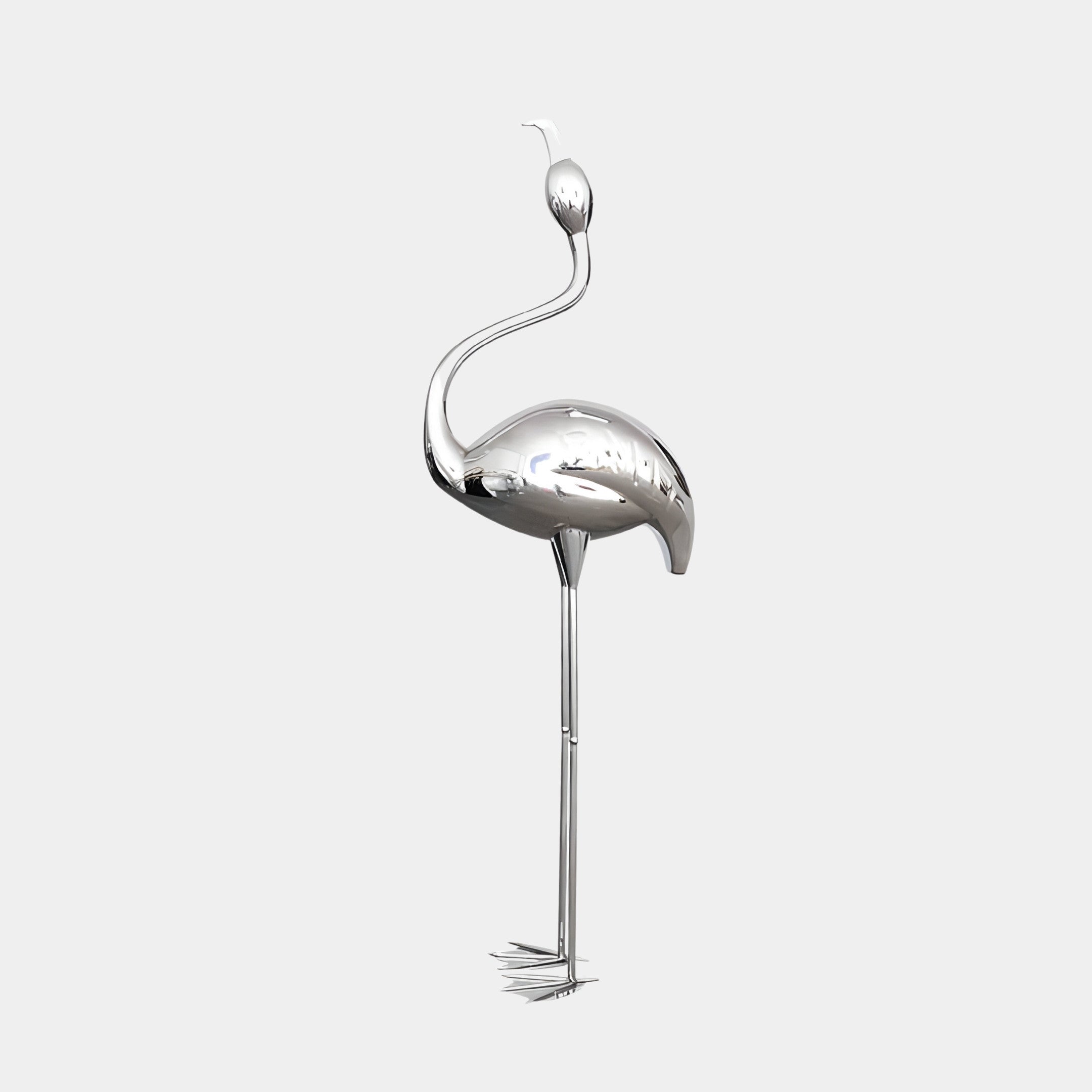 The Flamingo Stainless Steel Outdoor Sculpture by Giant Sculptures, standing at 94/147cm, is a silver metallic piece with long legs and a curved neck. Its sleek, reflective surface offers a minimalist design against a plain white background, perfect for outdoor display.