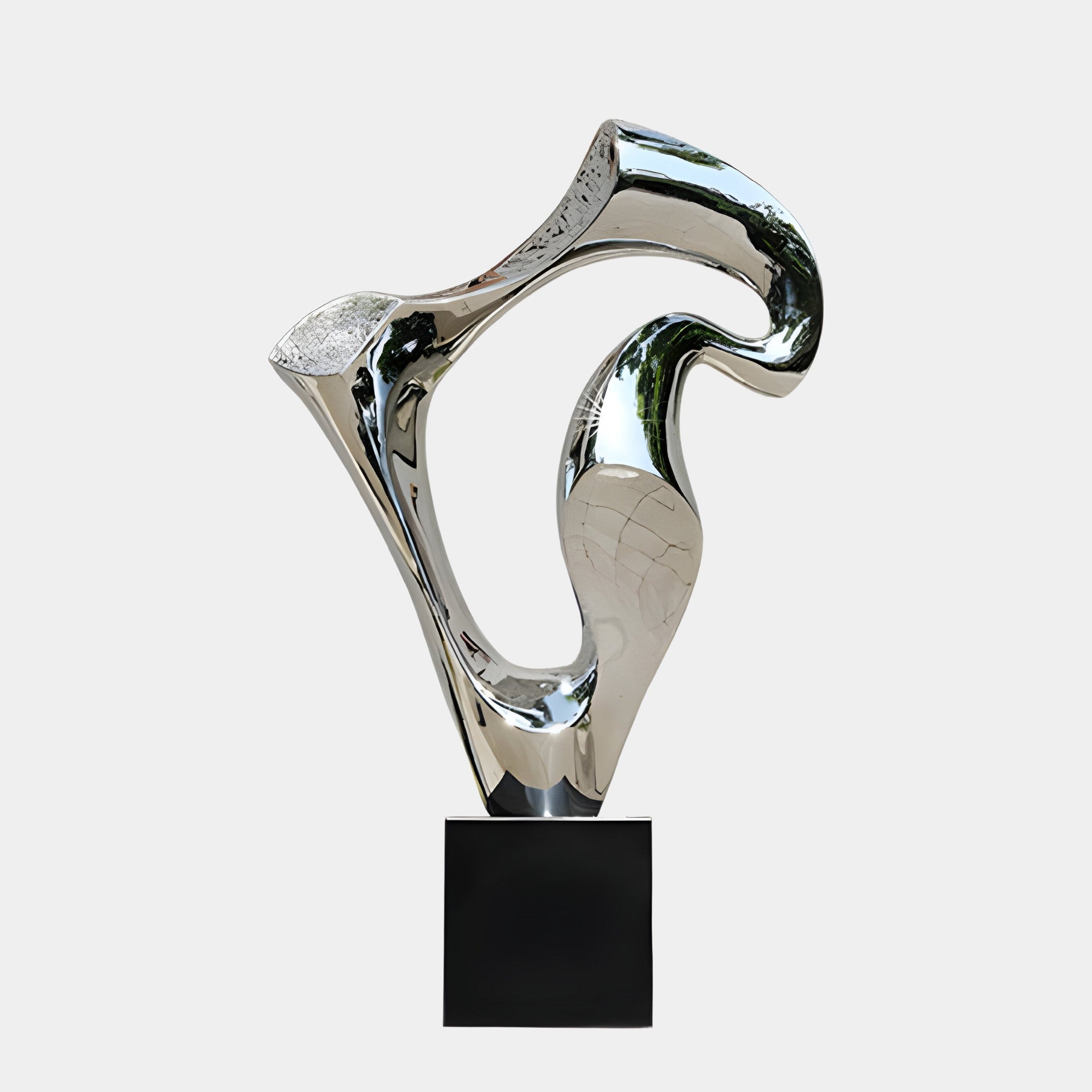 A polished silver sculpture with twisted, flowing lines on a black pedestal.