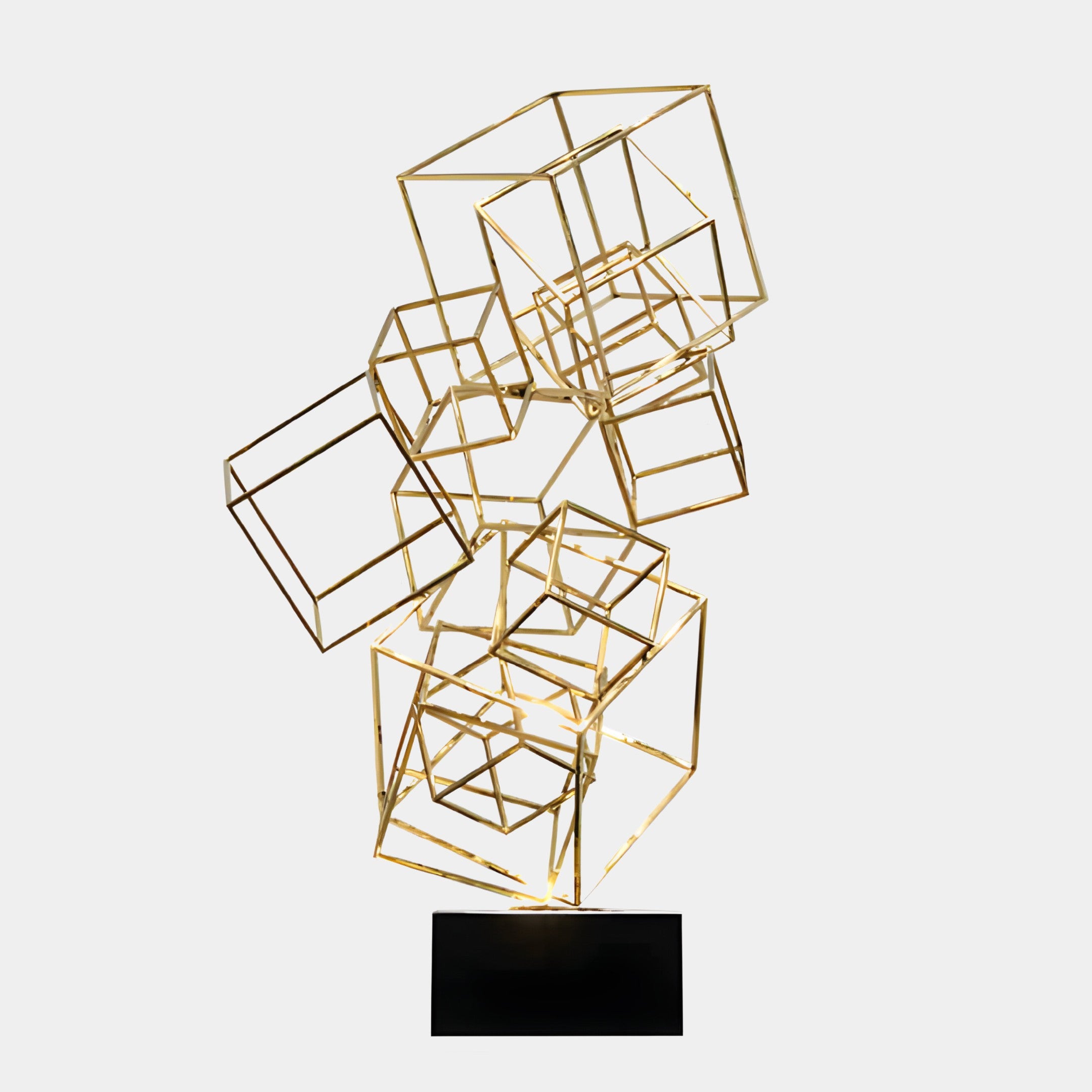 Geometric abstract sculpture made of interconnected golden wireframe cubes, displayed on a black base.