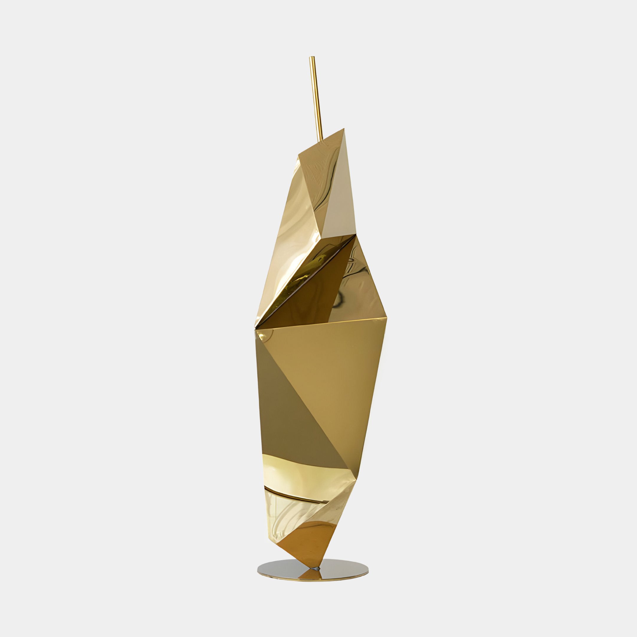 The Prism Gold Geometric Steel Sculpture by Giant Sculptures is an 80cm tall, modern masterpiece with a faceted design standing upright on a circular base. Made from reflective material, it captivates attention against a plain white background and exudes contemporary elegance.