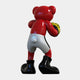 The Gacko Red LV Boxer Bear Sculpture - 200cm by Giant Sculptures features a glossy red bear in white shorts and black boots, holding a yellow and black ball, viewed from behind against a plain white background.