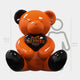 The Gacko Hermes Love Bear Sculpture - 160cm by Giant Sculptures features a shiny orange and black bear holding a heart labeled "Hermès Paris." A gray outline shows this luxury pop art piece stands 160 cm, slightly taller than an average person.