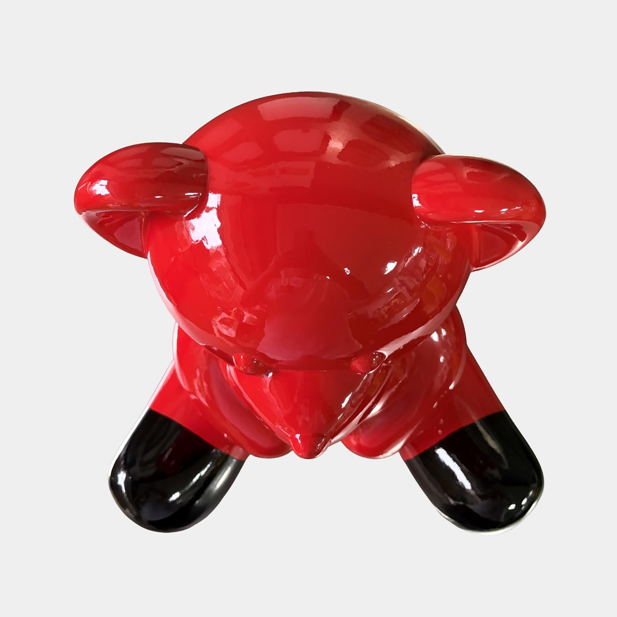 Overhead view of the 40cm Gacko Porsche Love Bear Sculpture, showing the high-gloss red lacquer catching light across the head, shoulders and outstretched limbs.