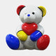 The Gacko Mondrian Love Bear Sculpture - 160cm by Giant Sculptures features a glossy white bear holding a red heart, with vibrant red, yellow, and blue accents in Pop Art style by André Gacko, set against a plain white backdrop.