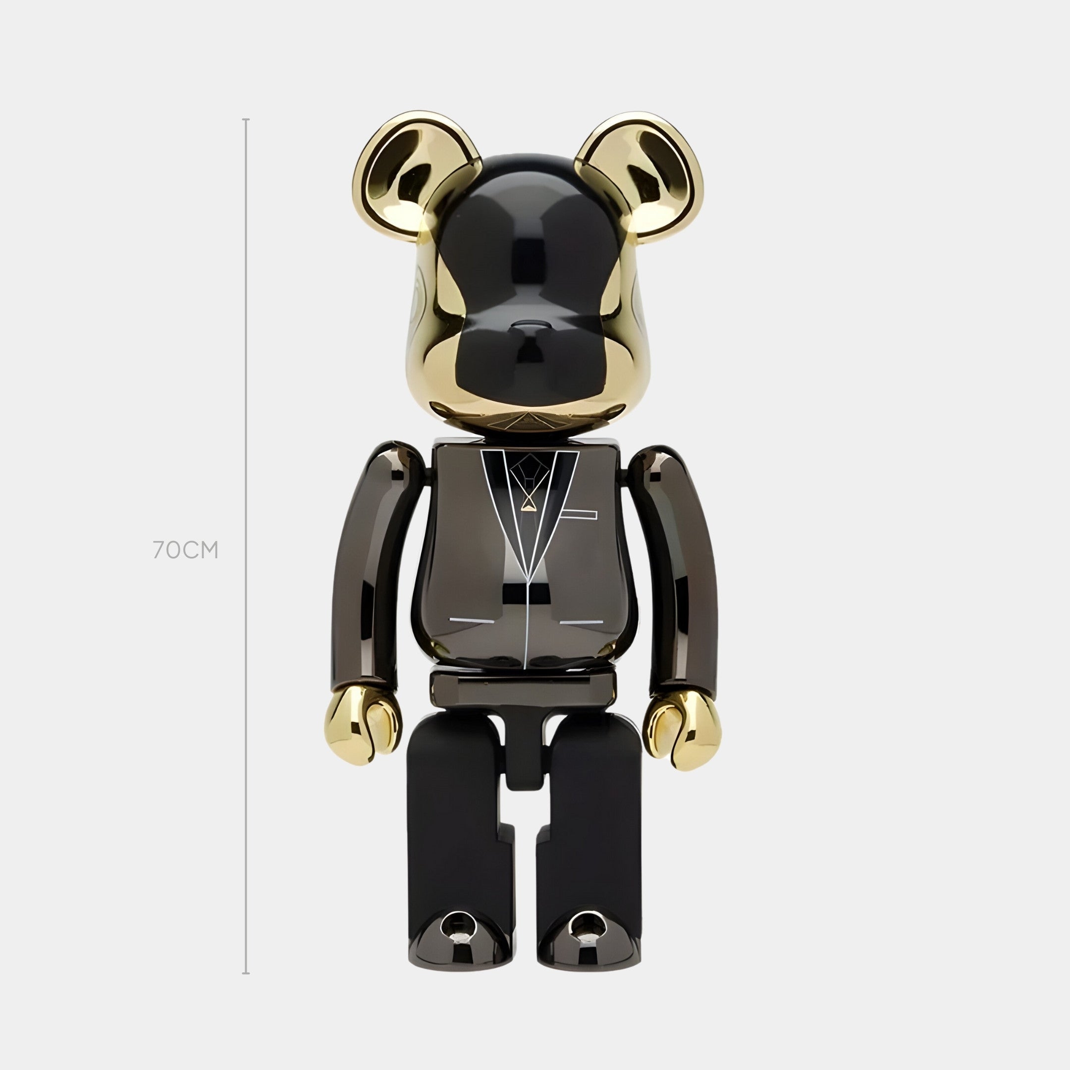 The Gala Gold Bear Sculpture - 70cm by Giant Sculptures stands upright in glossy black, with mirror-gold chrome ears, hands, and face. White geometric lines and a subtle tuxedo motif accent its chest for a sophisticated touch.