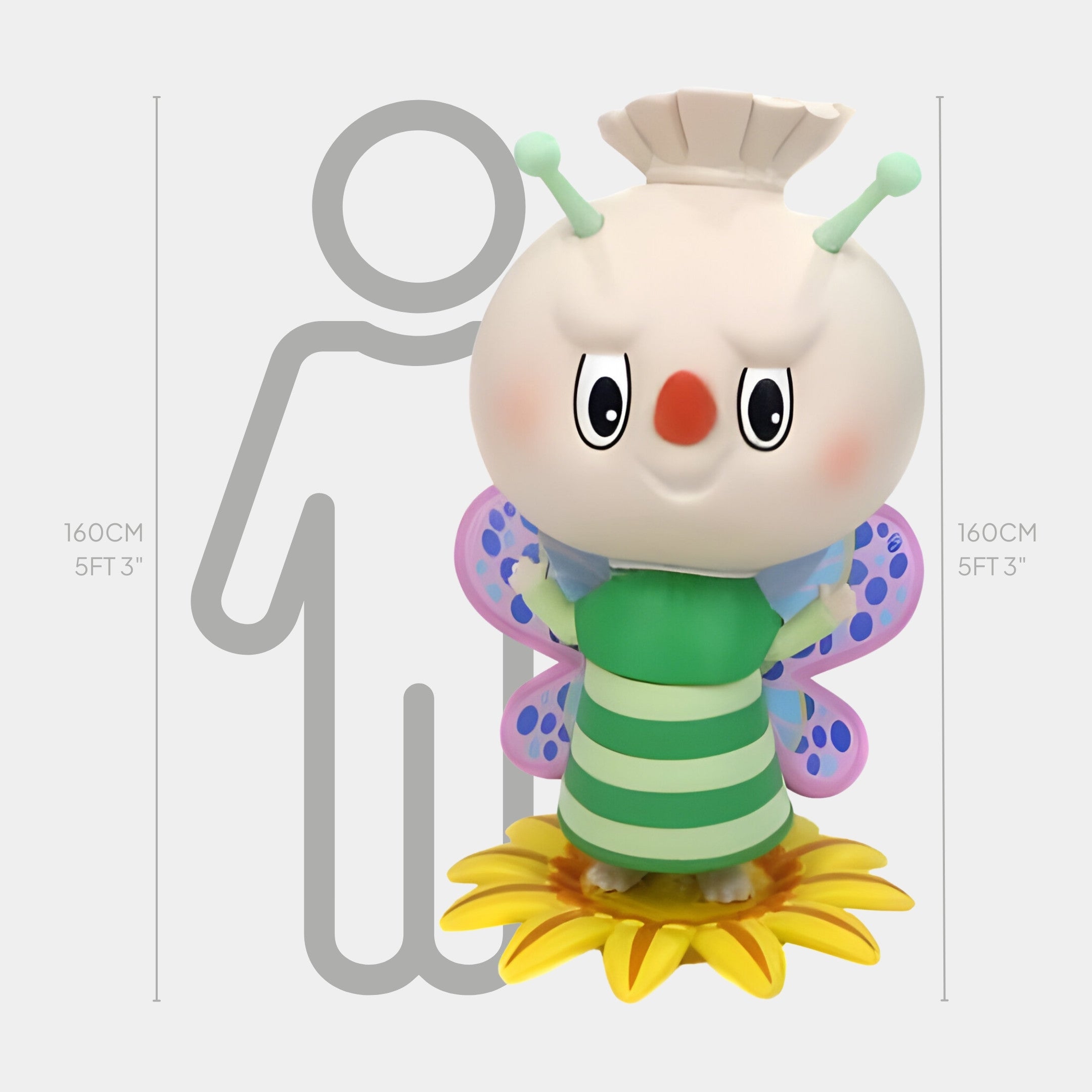 The Flower Elves Bee Fairy Labubu Sculpture by Giant Sculptures is a 160cm tall, whimsical interior art piece featuring a large butterfly figure with a round head, green antennas, and striped green body standing on a sunflower.