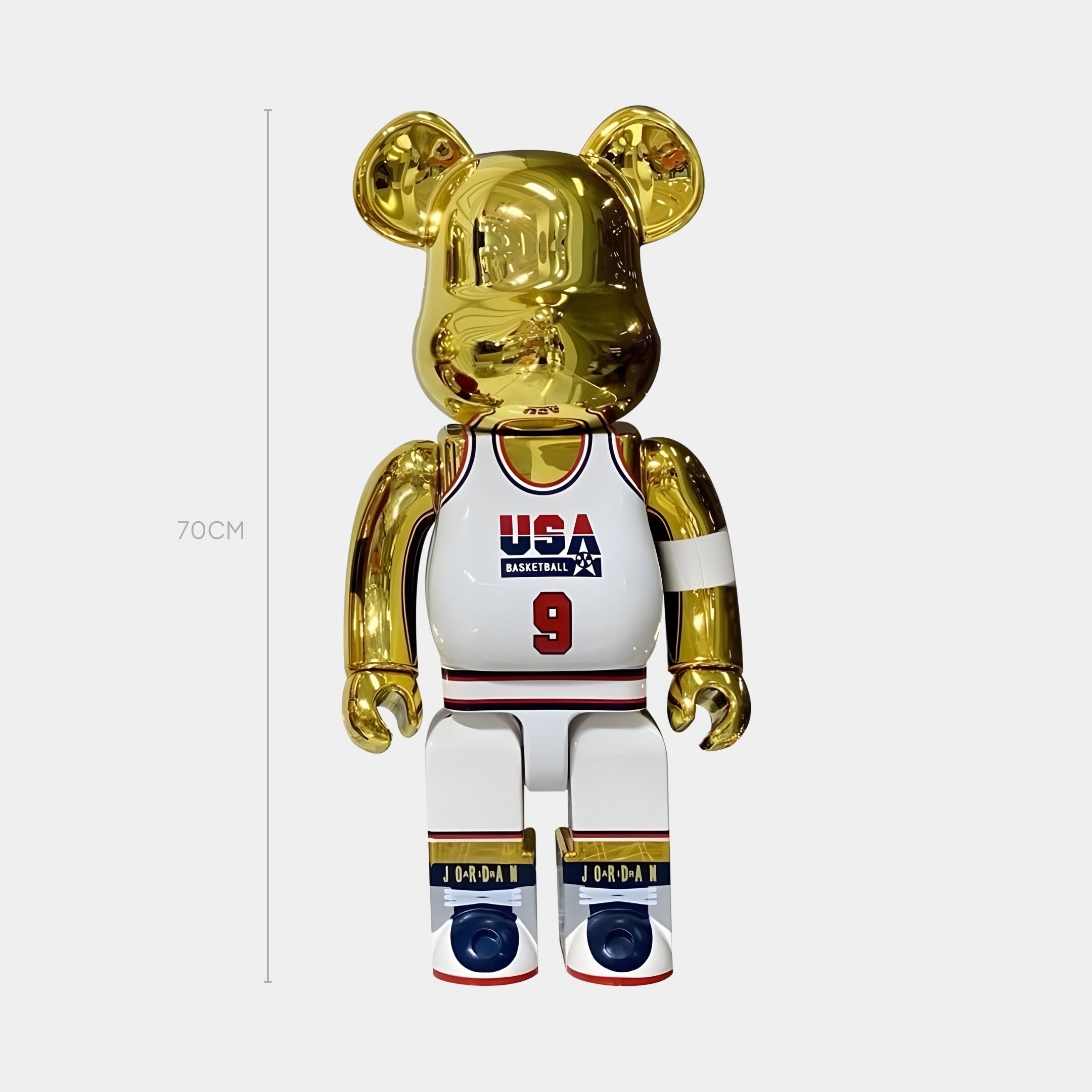 The All-Star Gold Court Bear Sculpture by Giant Sculptures stands 70cm tall, dressed in a white USA basketball jersey with number 9, white shorts, and red, white, and blue shoes—an ode to the iconic Dream Team.