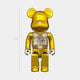 The Nexus Gold Bear Sculpture - 70cm by Giant Sculptures, with electro-plated gold chrome finish, stands upright. A transparent chest displays 2G, emphasizing its limited-edition status against a light gray background.