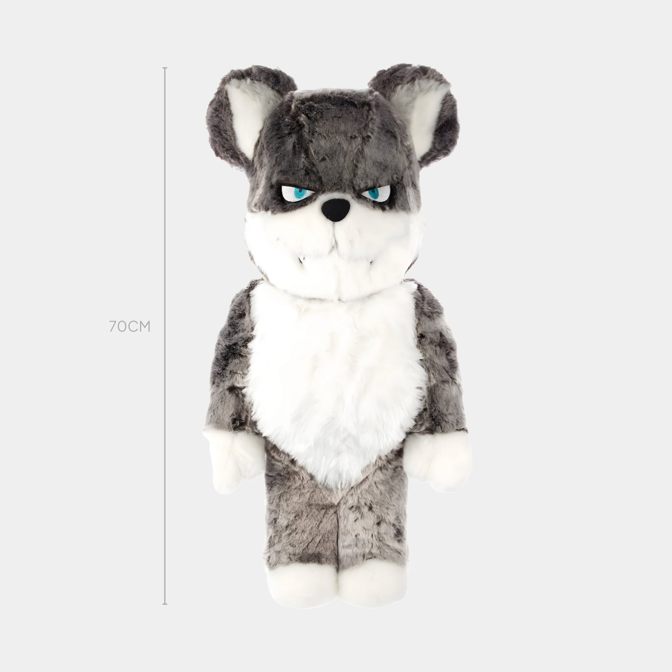 The Giant Sculptures Polar Husk Fur Bear Sculpture - 70cm features a gray and white wolf-like plush with blue eyes, upright ears, and an intense look, made from soft faux fur for Arctic Comfort, set against a plain light background.
