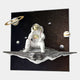 The White 3D Galaxy Astronaut Thinker Starry Wall Art by Giant Sculptures features a resin astronaut on a floating rock among stars and planets, including Saturn, extending outward from a square flat backdrop for striking space-themed decor.