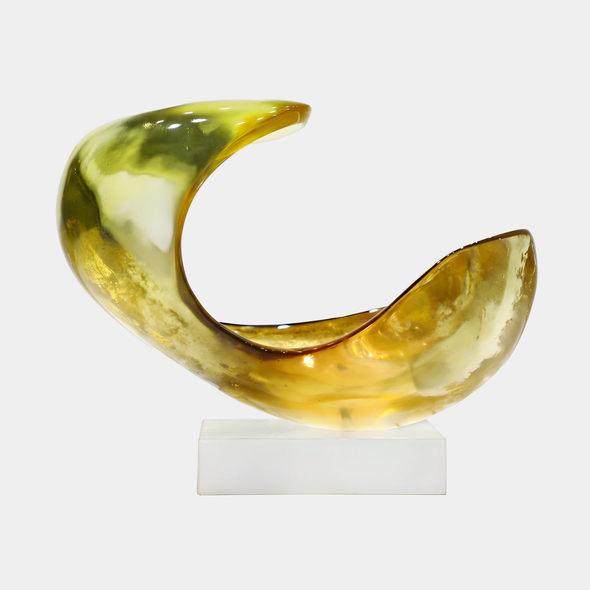 Amber & Olive Hooked Crescent Resin Sculpture, 36cm, on a white marble block with a plain background, showing olive tones through the hooked end and amber-honey filling the open scoop.