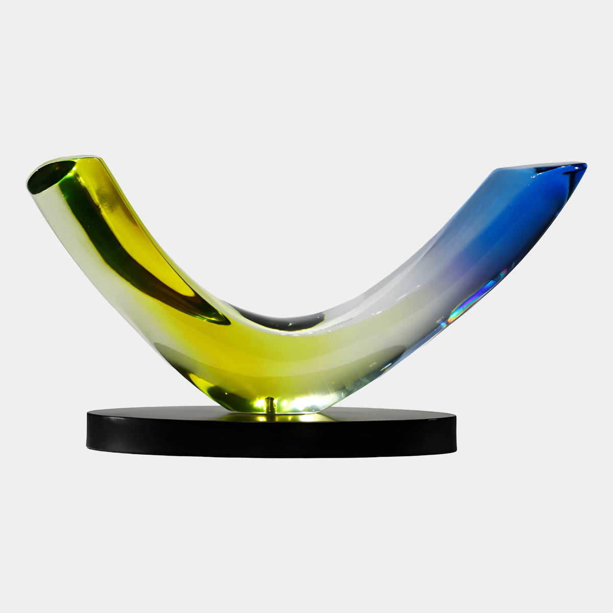 Yellow & Blue Graded Bent Horn Resin Sculpture, 48cm, curved horn shape gradating from yellow to blue on a round black marble base, plain white background.