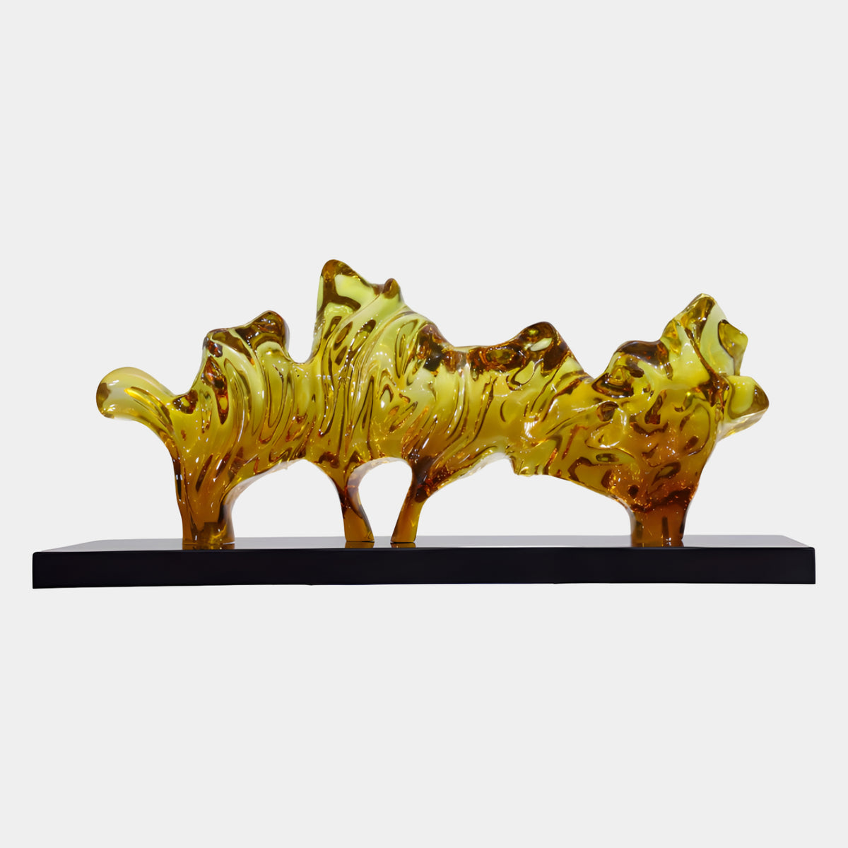 Yellow & Orange Craggy Ridge Resin Sculpture, 86cm, a jagged amber and yellow ridge on four cast legs atop a black marble base, shown against a plain white background.
