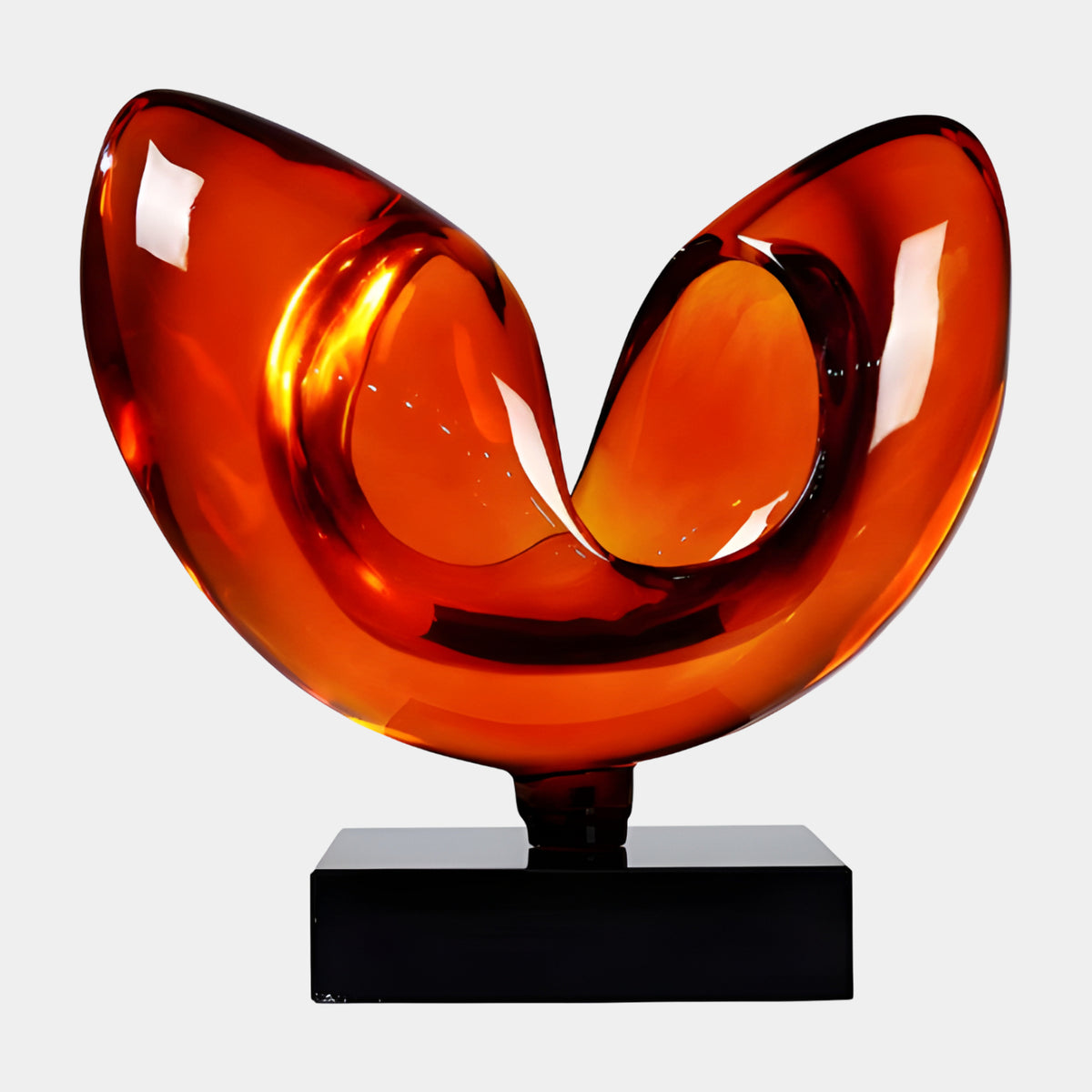Orange Twin Lobe Curl on Marble Resin Sculpture, 47cm, glossy orange two-lobed heart-shaped form on a black marble base, plain white background.