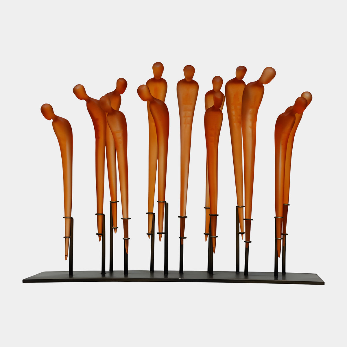 Orange Standing Figure Group Resin Sculpture - 80cm, thirteen frosted amber resin figures on slender metal posts of varying heights along a black bar, set against a plain white background.