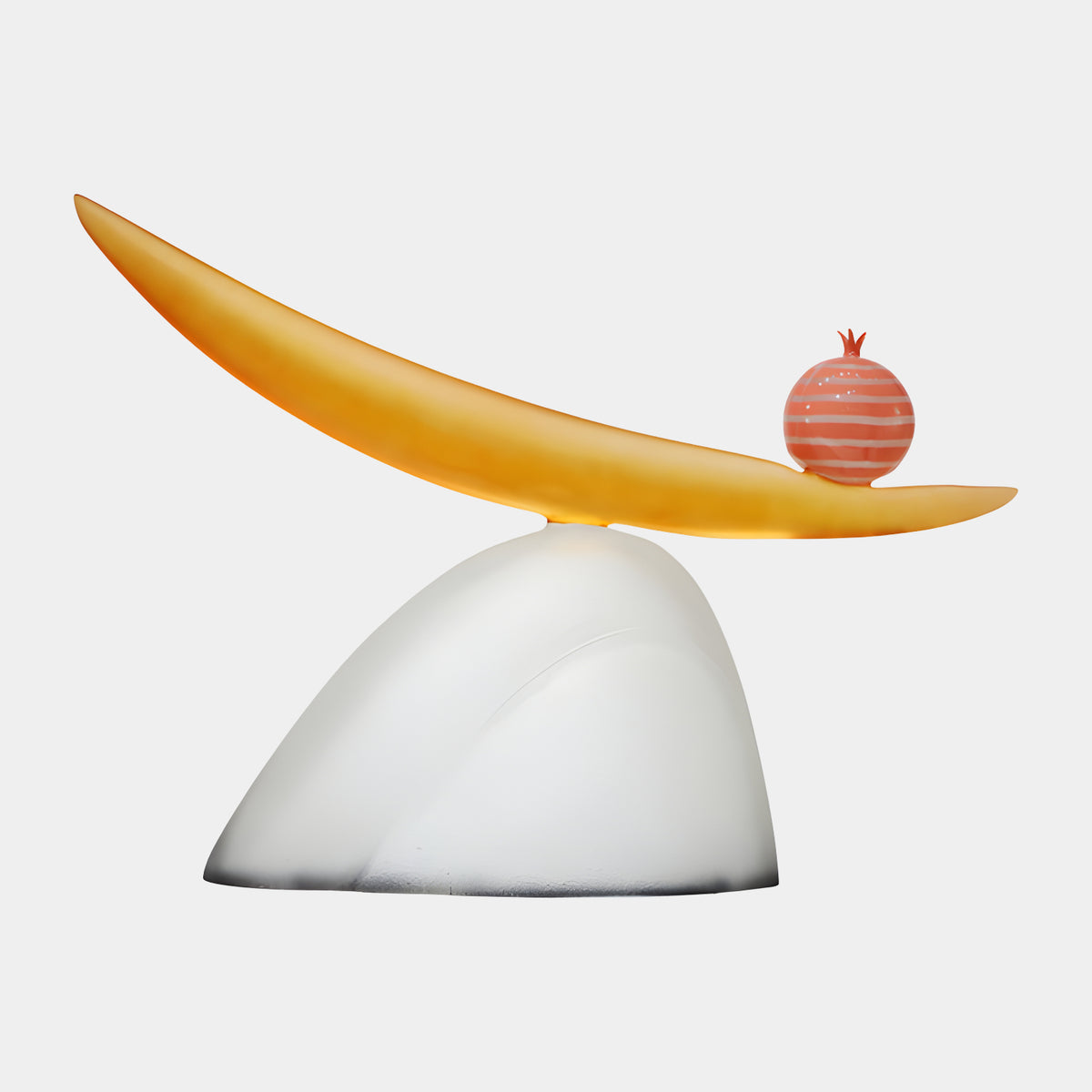 Amber & White Balanced Blade & Pomegranate Resin Sculpture, 106cm, with a frosted amber blade tilted atop a white mound, a coral and white striped pomegranate resting near its lower end, on a plain light background.