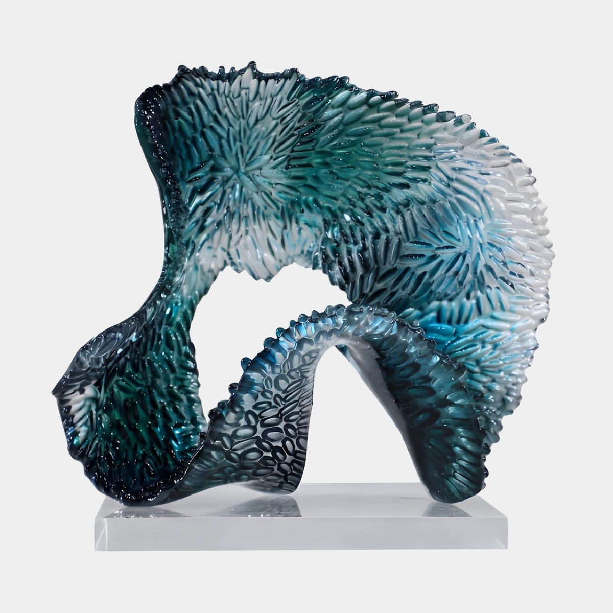 Teal Scaled Looping Sweep Resin Sculpture - 34cm by Giant Sculptures, an arching looped form with radiating scale texture fading from deep teal to white, on a clear acrylic base against a plain light background.