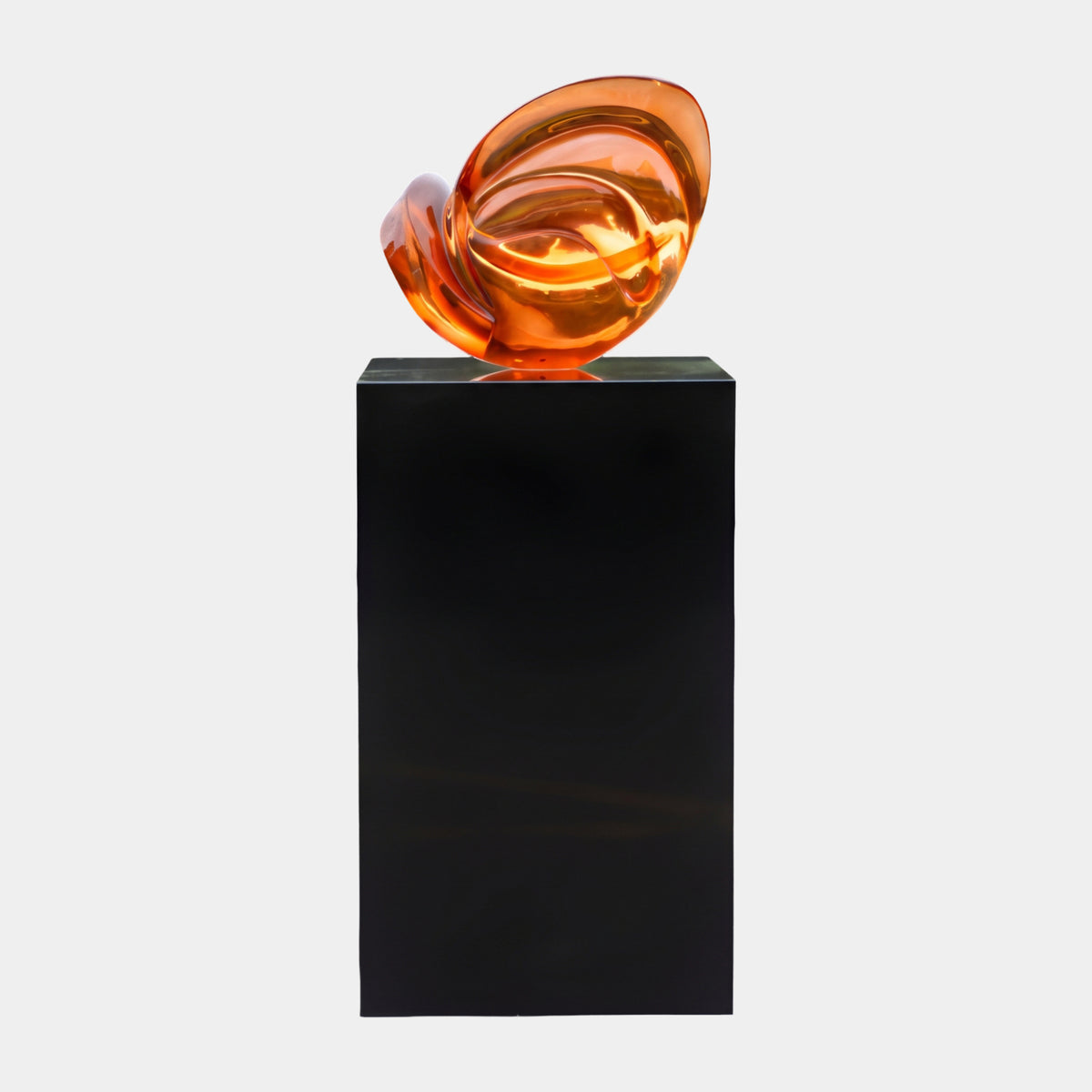 Amber Curled Shell Resin Sculpture on Black Plinth - 133cm, a spiraled amber-orange resin form atop a tall black square plinth, shown against a plain light grey background.