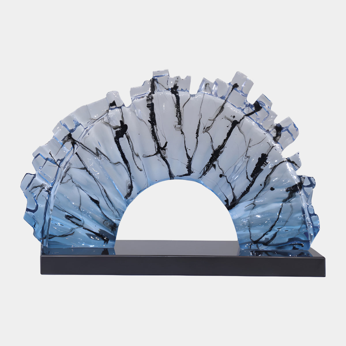 Blue Ink-Trail Shard Arch Resin Sculpture, 58cm, fan-pleated arch with jagged shard edges, blue fading to clear with black ink trails, on a black marble base against a white background.